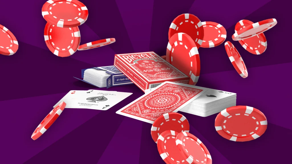 A red deck of playing cards is stacked on a blue deck, with cards face-up in front; red poker chips float around the cards.