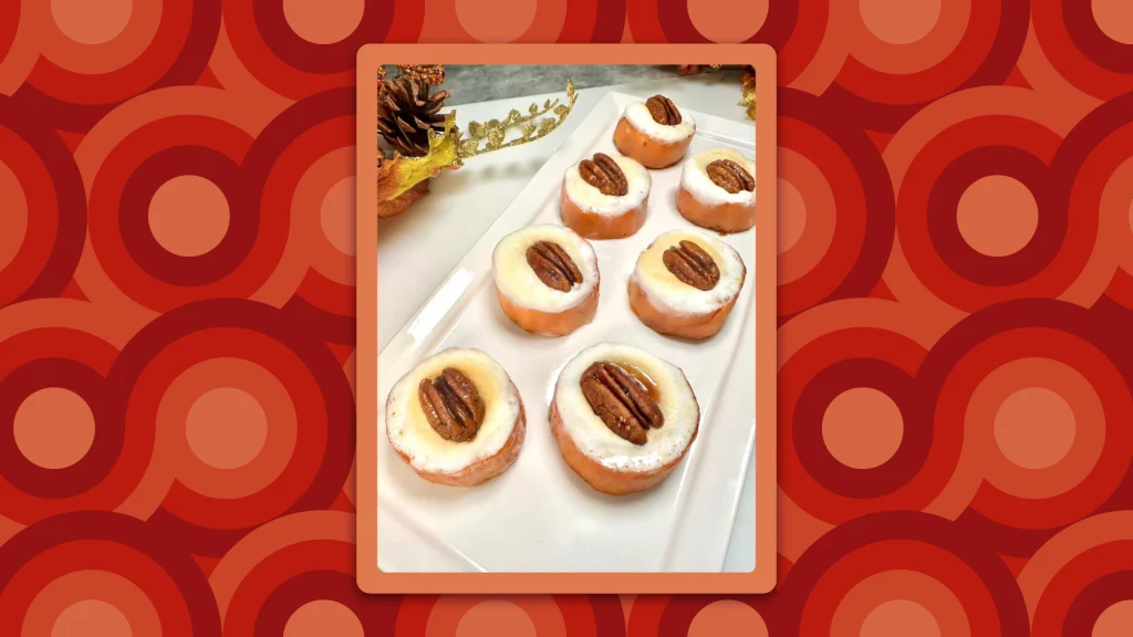 Sweet potato marshmallow bites rest on a white dish on a counter, surrounded by a retro-style border. 