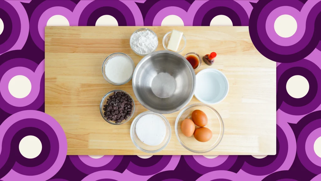 The ingredients for a red velvet lava cake recipe including bowls filled with flour, eggs and chocolate chips.